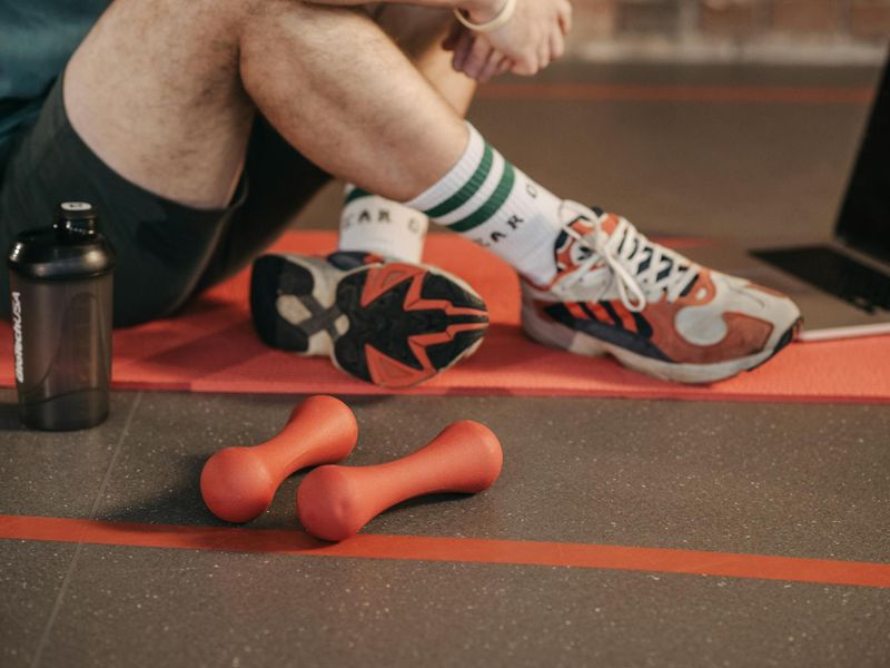 Close up of sneakers and water bottle on gym floor